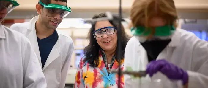 Carnegie Mellon students working with their professor in a tie dye lab.